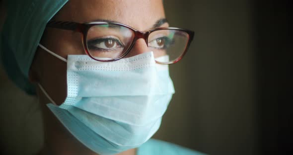 Young female medic, wearing a mask and glasses