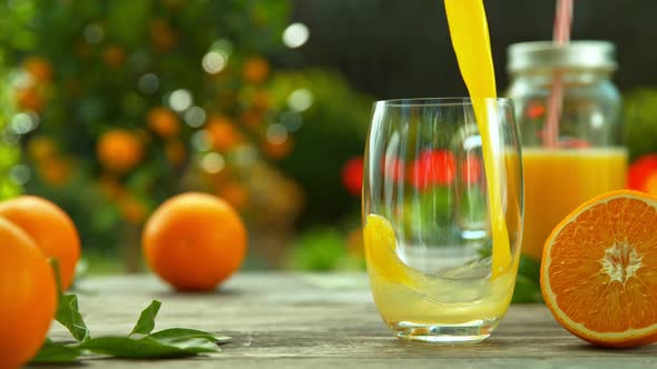 Super Slow Motion Shot of Fresh Orange Juice Being Poured in a Glass at 1000Fps alt