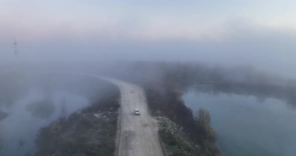 Aerial Cinematic Slow Motion Drone View of a Path at Sunrise Surrounded By Fog
