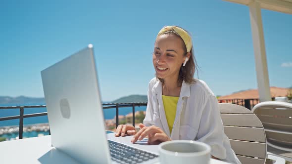 Attractive Mixed Rase Woman Enjoying Morning Coffee While Sitting on Terrace with Sea View on alt