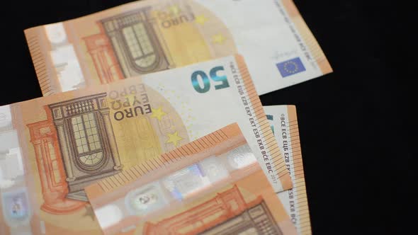 A man counts money - euro banknotes with a face value of 50 euros