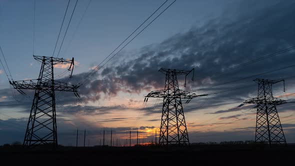 Time lapse Sunrise high voltage power line Electric towers. Electricity pylons