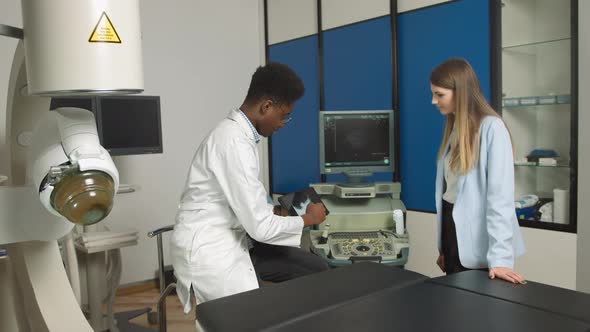 African American Family Medical Doctor in Modern Clinic Holding Tablet Pc and alt