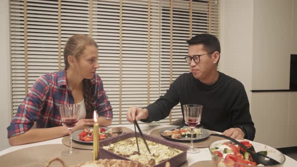 Young Diverse Couple Dining At Home