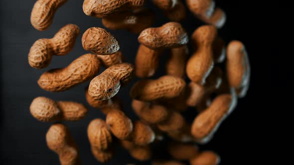Inshell Peanuts Levitate in Slow Motion. Macro alt