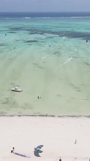 Vertical Video Kitesurfing Near the Shore of Zanzibar Tanzania alt