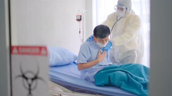Slow motion of doctor and nurse with full covered PPE suit check symptom and analysis patient alt