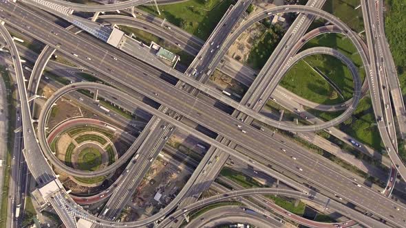 Aerial View of Highway Road Interchange with Busy Urban Traffic Speeding on Road alt