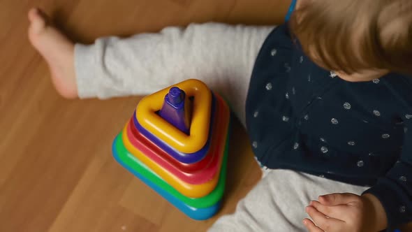 Child Plays with Designer Kit on the Floor, Top View