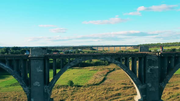 Lady Tourist Is Enjoying the View on the Old Stone Bridge alt