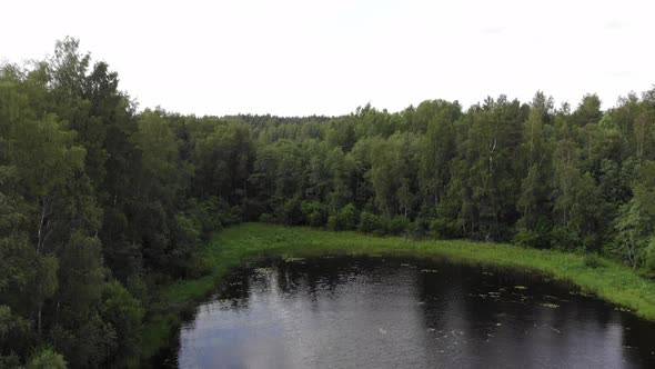 Swampy place at Murolahti bay, aerial camera fly back and up, reveal shot alt