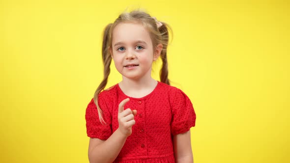 Middle Shot of Cute Charming Little Girl Shaking Finger in Slow Motion Disapproving alt