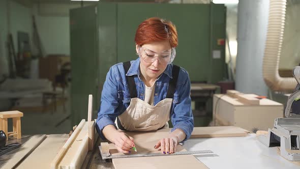 Hardworking Focused Professional Serious Carpenter Woman Holding Ruler and Pencil