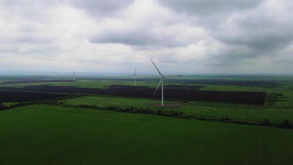 Wind Turbines Rotating at Renewable Sustainable Energy Farm on Cloudy Day