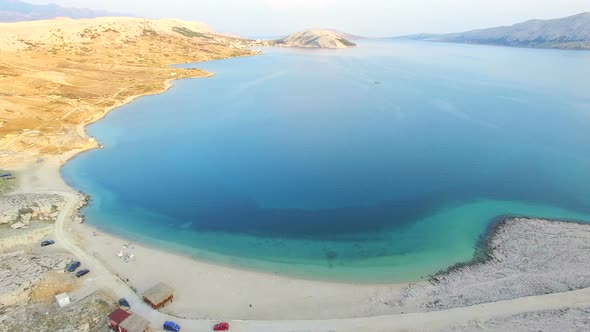 Aerial view of turquoise sea and yellow grass of Pag island, Croatia alt