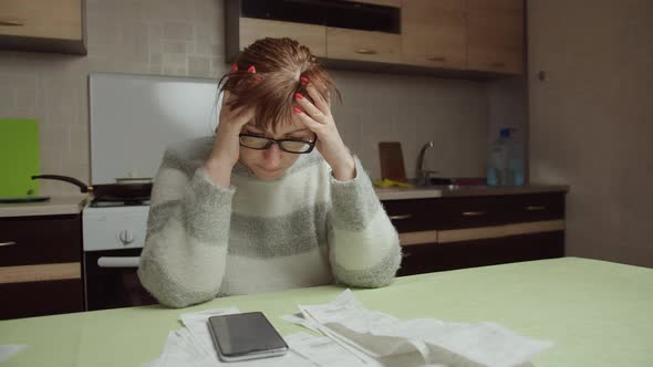 Woman Examines the Purchases Made and the Prices at Home Shopping Spends a Lot of Money alt