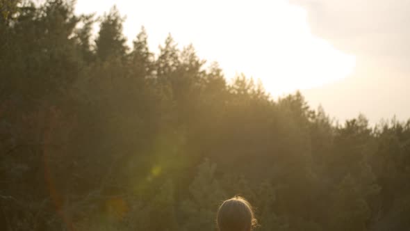 Girl Meditates in Open Nature
