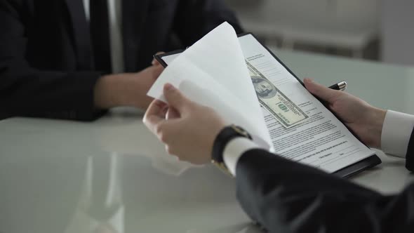 Man Signing Contract Seeing Money Between Pages, Bribe, Prosperity of Corruption alt