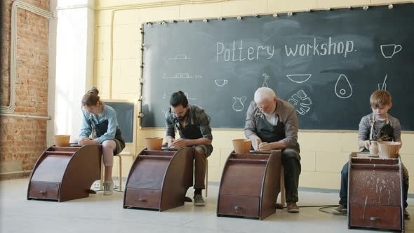 Adult People and Child Working with Pottery Wheel in Workshop Busy with Creative Activity alt