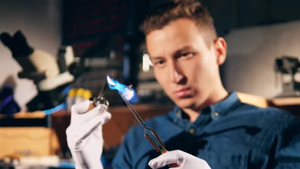 Setting of the Ring Is Getting Burnt By a Male Jeweler alt