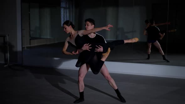 Cheerful Young Couple of Ballet Dancers Rehearsing Smiling in Studio Indoors alt