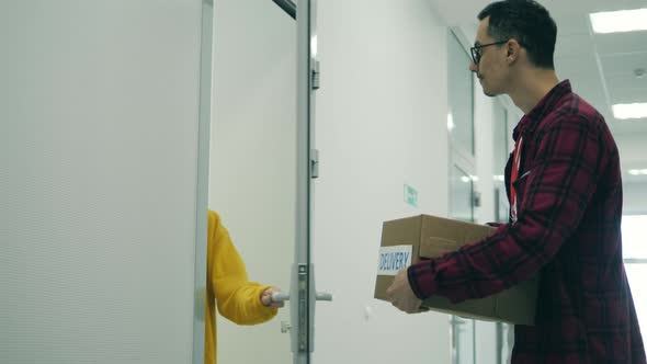 A Man Is Taking Out Boxes for Delivery From the Car Trunk alt
