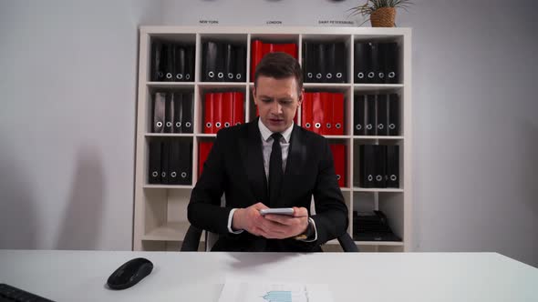 Businessman Listening To You and Precise Your Question By Mobile Phone alt