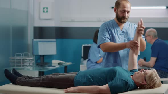 Senior Woman Receiving Medical Assistance From Osteopath alt