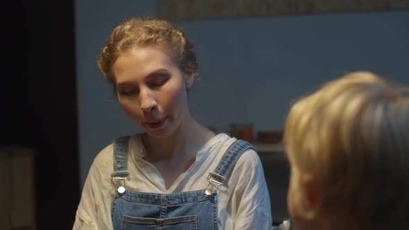 Woman in a Cute Jumpsuit Is Talking with Her Son alt