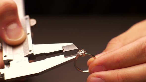 Man Measures Diameter of Diamond in Ring