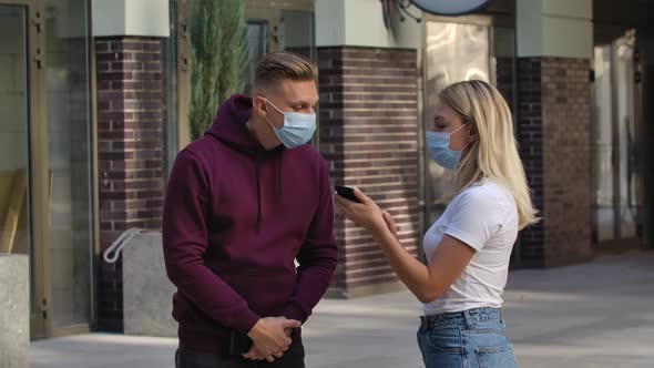 Portrait of Young Man and Woman Communicate. Woman Learns How To Get To the Right Place By Showing a alt