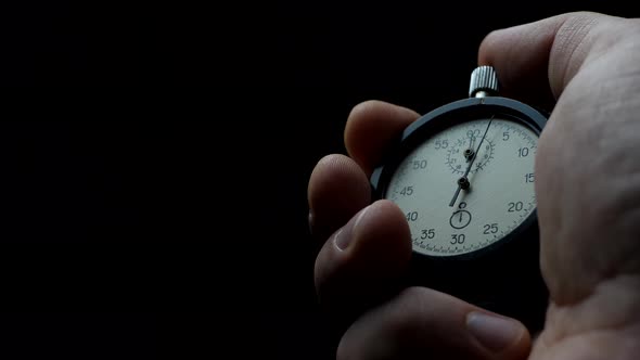 Analogue Stopwatch in Man Hand alt