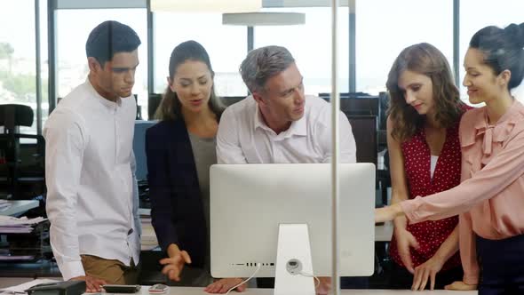 Business people working together on computer at desk in a modern office 