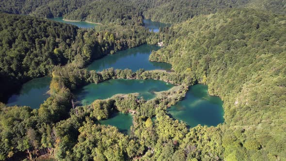 Flying over the famous Plitvice Lakes with forest at summer in Croatia, Europe alt