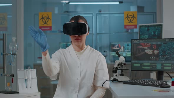 Chemist Working with Virtual Reality Headset in Laboratory alt