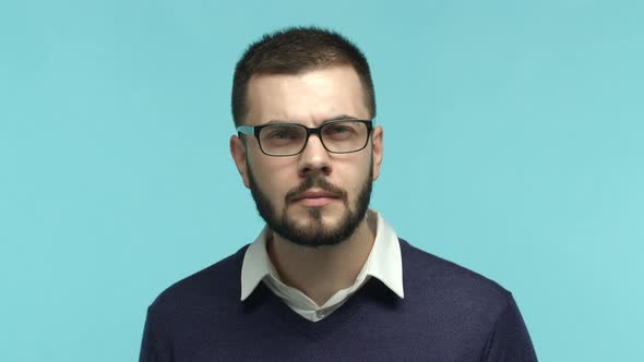 Close Up of Handsome Caucasian Man with Beard Wearing Glasses Squinting Eyes Cant Read Something