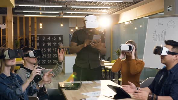 Team of Young Business Man and Woman Using VR Virtual Reality Glasses in the Modern Office alt