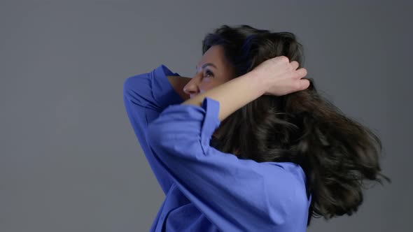 Pretty Female Shocked Mature Woman on Grey Background. OMG, Wow Effect. alt