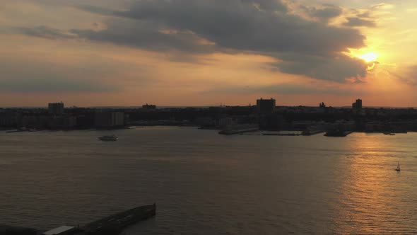 high view at the horizon, golden sunset, then descends, truck left down to train yard below slowly alt
