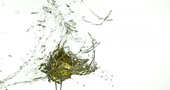 900049 Glass of White Wine Breaking and Splashing against White Background, Slow motion 4K alt