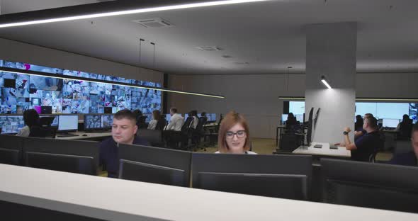 Security Guards Monitoring Modern CCTV Cameras in Surveillance Room alt