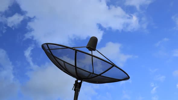 Time-lapse of Satellite dish with blue sky and cloud background alt