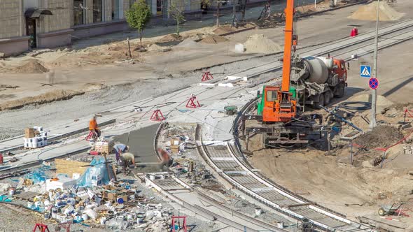 Concrete Works for Road Construction with Many Workers and Mixer Timelapse alt
