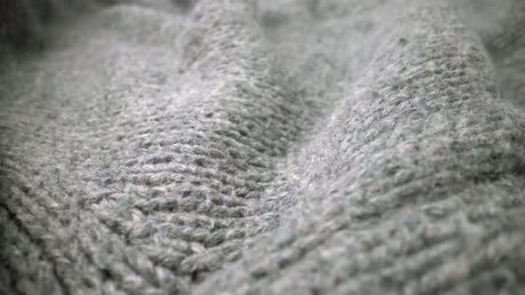 Extreme detail view of sheep wool cloth texture flowing in macro dolly shot. alt