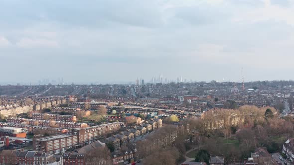 Slider sideways drone shot over suburban north London looking towards city centre alt