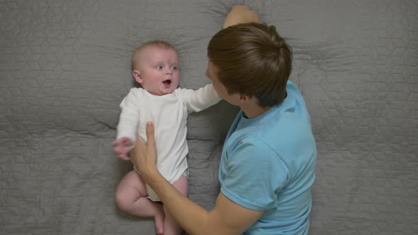 Father Talking To Baby alt