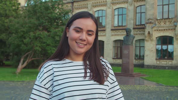 Closeup Portrait of Lovely Teenage Asian Girl Smiling Outdoors alt