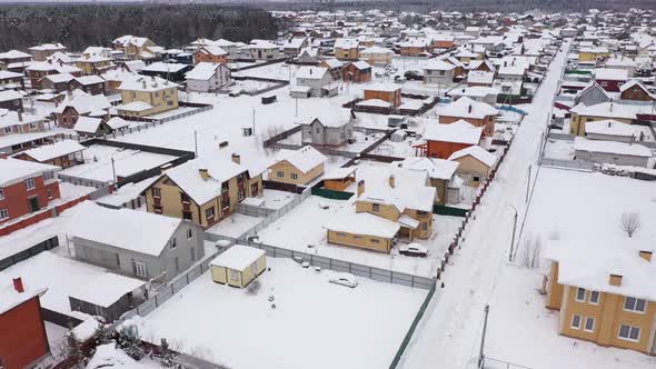 Panoramic Aerial View of Cottages Village Covered By Snow in Winter