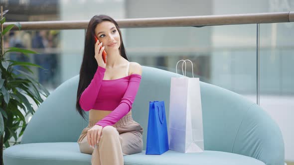 Happy Woman Talking on Phone in Shopping Mall alt