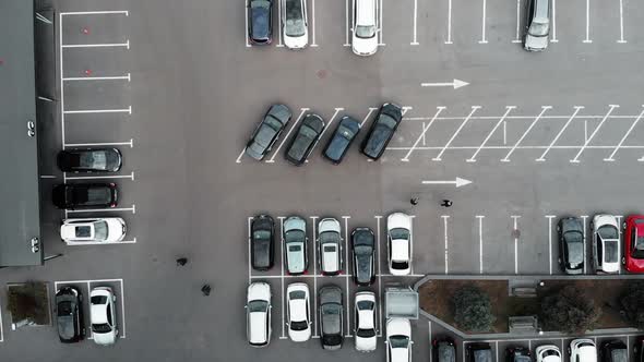 Top Drone View of Busy Car Parking with People Walking from Cars to Office alt